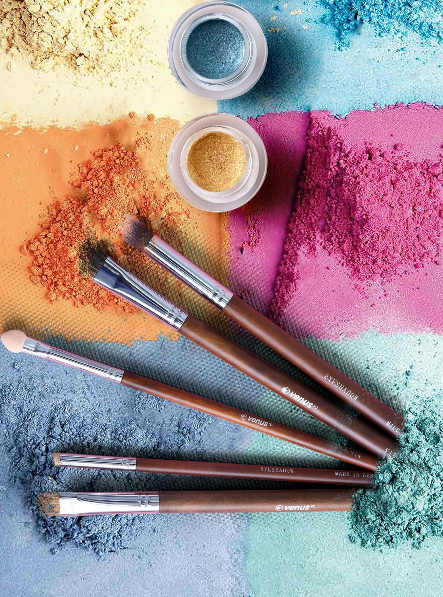 Colorful makeup powders and brushes in an artistic flat lay composition.