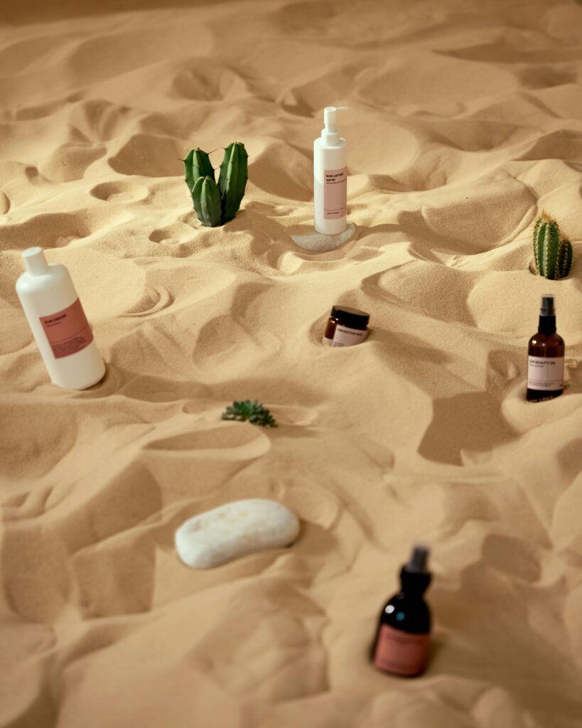 Creative skincare products presented on a desert sand backdrop for a unique visual experience.